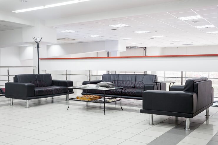 reception with handmade black leather sofas