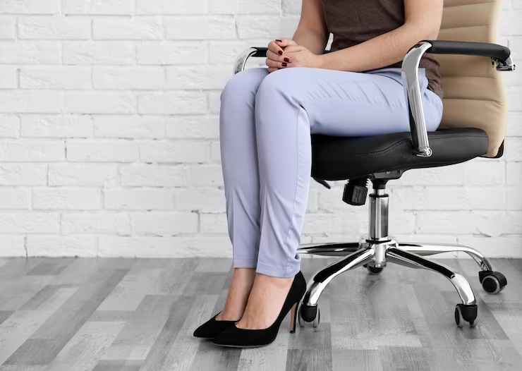 woman sitting office chair indoors
