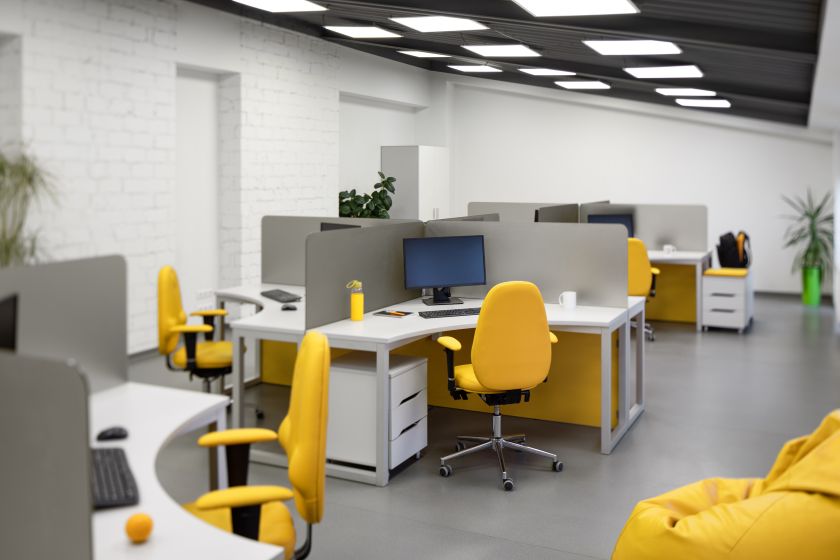 IT Office with workplace computer and yellow chairs