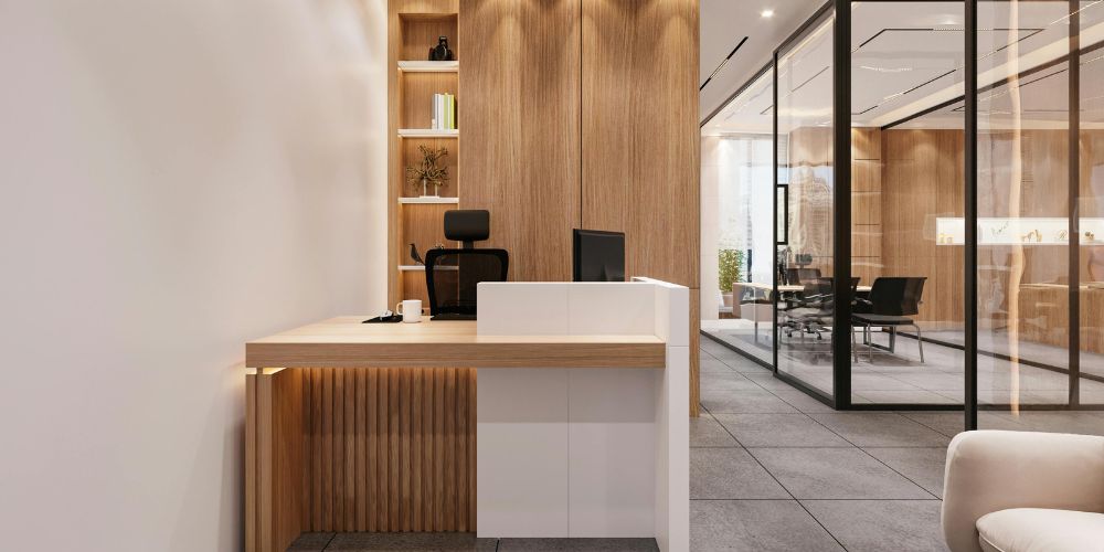 A modern office reception desk featuring light wood paneling and white accents