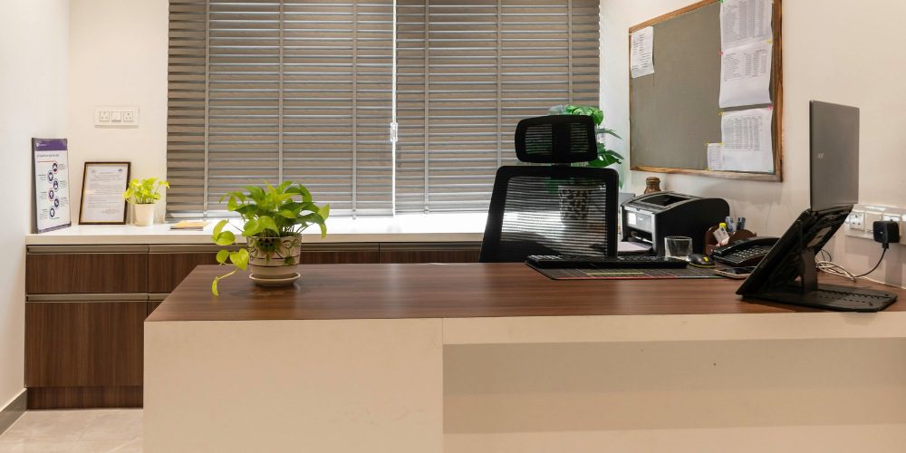 a modern office workspace featuring a large, two-tone reception desk