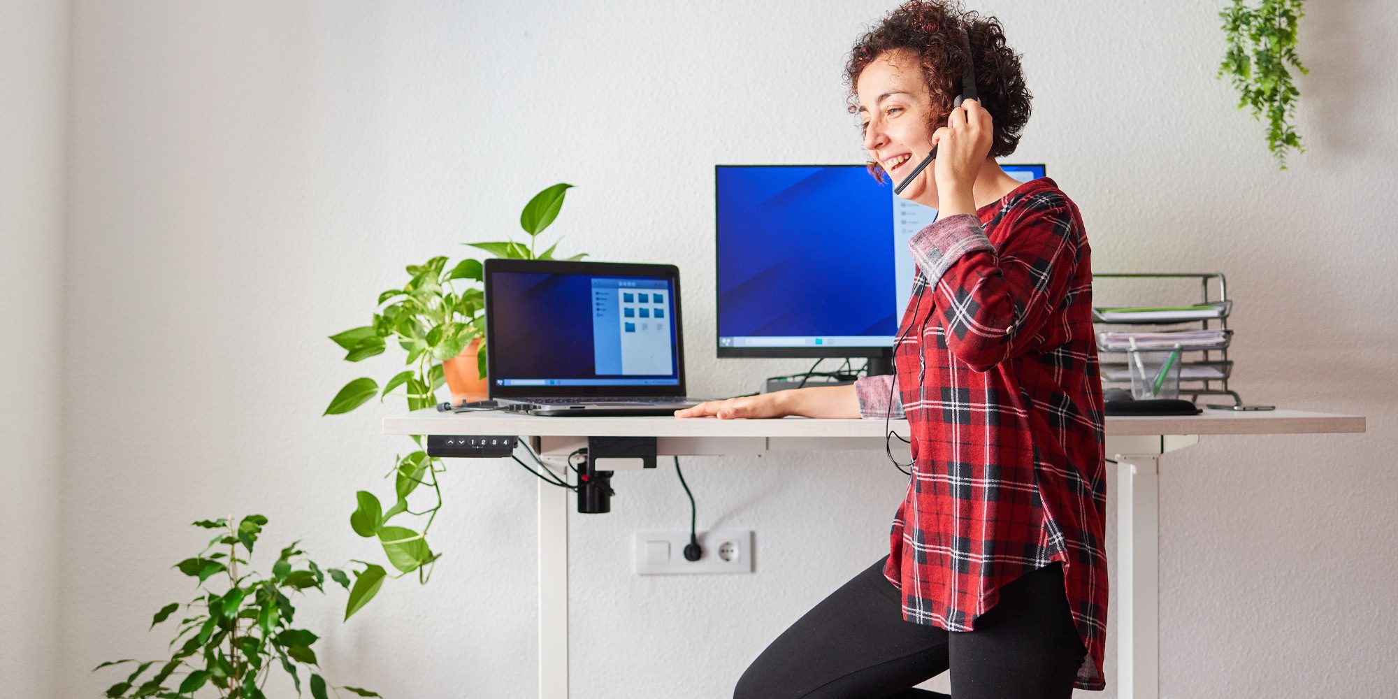 a woman working with an adjustable standing desk