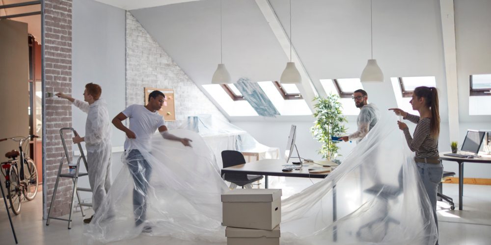 team of workers prepping an attic-style office space