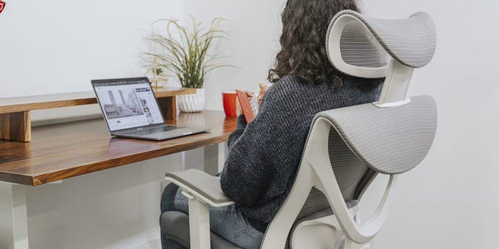 sitting in a white ergonomic office chair